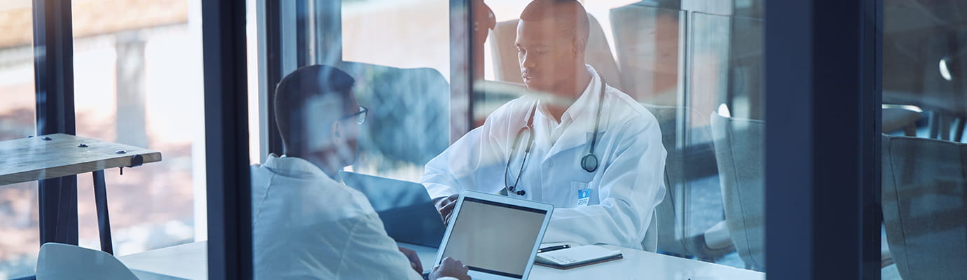 doctors working on computers in an office room