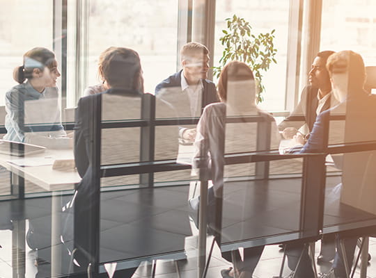 a team sitting at a table for a business meeting