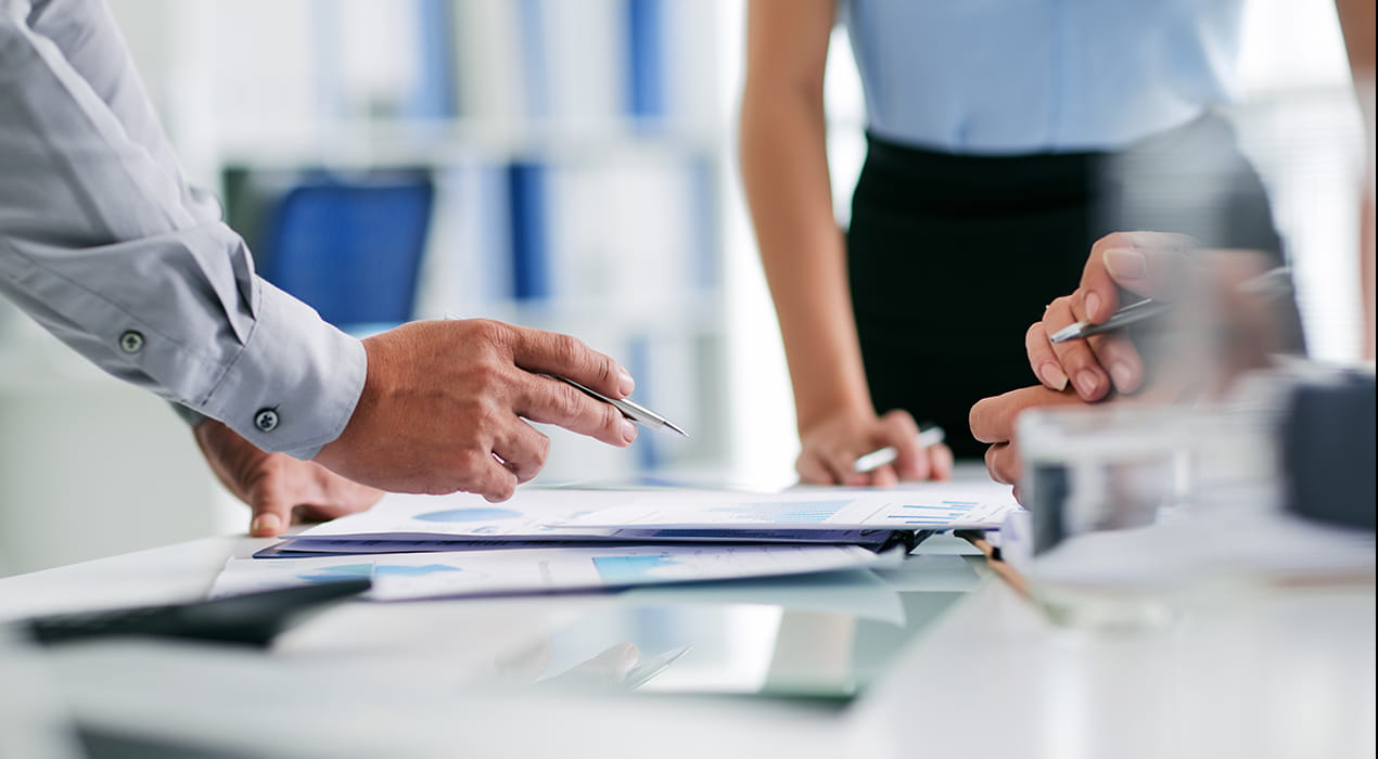 human hands holding a pen and paper