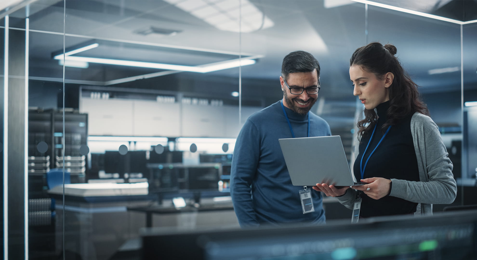 two coworkers reviewing work on a laptop computer