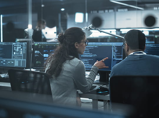 erp team looking at data on a computer