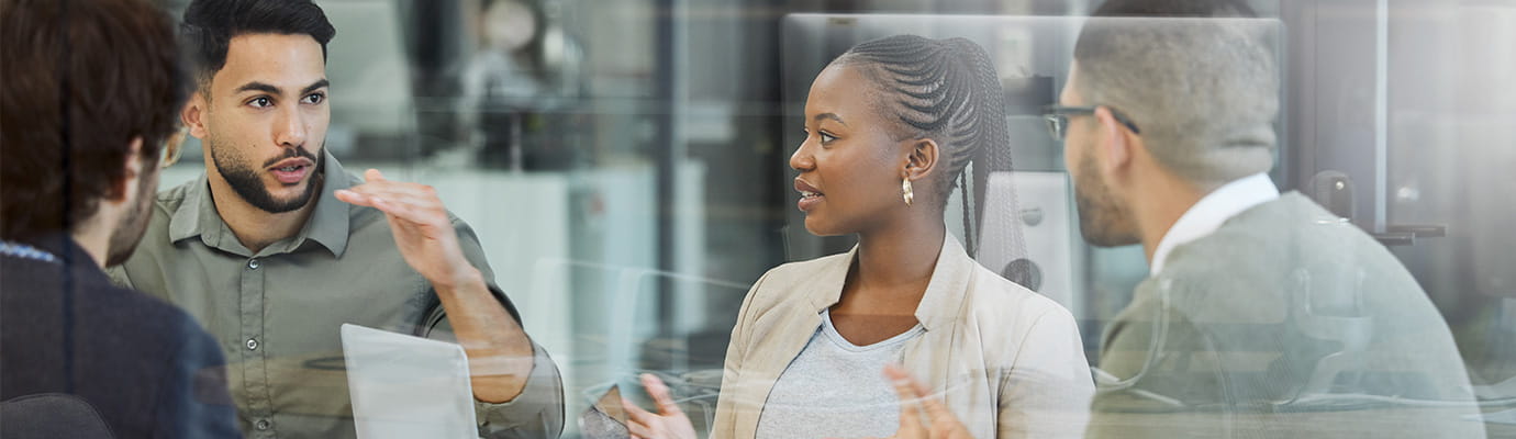 a team in an office talking to each other