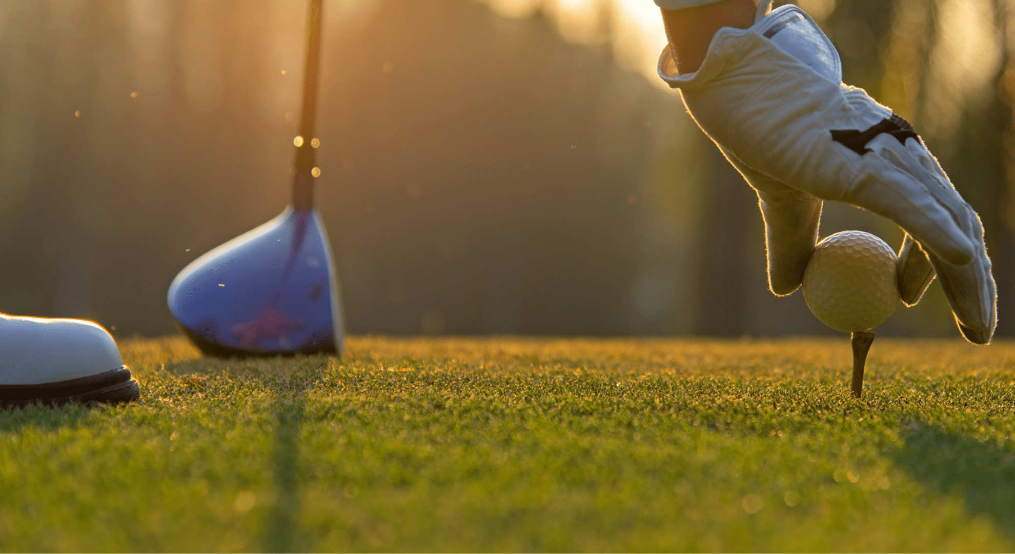 putting a golf ball on a tee