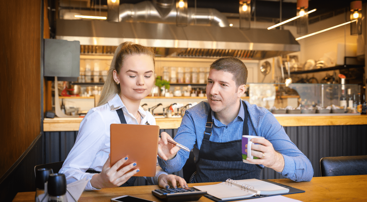 two workers analyzing financials in a restaurant setting