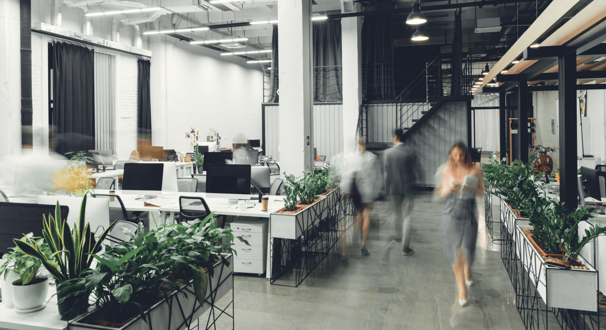 people walking through an office